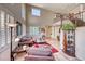 Open-concept living room with high ceilings, large windows, comfortable seating, and staircase at 2733 Auchmull St, Henderson, NV 89044