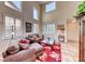 Bright living room with high ceilings, large windows, comfortable seating, and a decorative rug at 2733 Auchmull St, Henderson, NV 89044