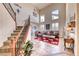 Bright living room with comfortable seating, high ceilings, a cozy rug, and a staircase at 2733 Auchmull St, Henderson, NV 89044