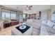 A bright living space with a large sectional sofa, and an open flow into a kitchen and dining area at 2733 Auchmull St, Henderson, NV 89044
