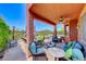 Covered patio with comfortable seating, ceiling fan, and views of the surrounding landscape at 2733 Auchmull St, Henderson, NV 89044