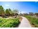 Paved community path with shade trees, lush landscaping and nearby picnic area at 2733 Auchmull St, Henderson, NV 89044