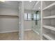 Bright bathroom with glass shower, tiled feature wall, and linen closet at 3061 Waterside Cir, Las Vegas, NV 89117
