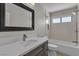 Stylish bathroom features marble vanity with modern faucet and tiled shower with tub at 3061 Waterside Cir, Las Vegas, NV 89117