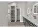 Bright bathroom with dual vanity, modern fixtures, and plenty of storage shelving at 3061 Waterside Cir, Las Vegas, NV 89117