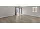 Light-filled bedroom with wood flooring, neutral walls, and sliding glass door at 3061 Waterside Cir, Las Vegas, NV 89117
