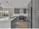 A stylish kitchen showcasing gray cabinets, stainless steel appliances, and a bright white countertop with neighborhood views at 3061 Waterside Cir, Las Vegas, NV 89117
