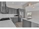 Bright kitchen with stainless steel appliances, gray cabinets, and marble countertops, perfect for cooking and entertaining at 3061 Waterside Cir, Las Vegas, NV 89117