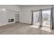 Bright living room boasts fireplace with decorative tile and sliding glass doors to backyard at 3061 Waterside Cir, Las Vegas, NV 89117