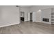 Spacious living room featuring open floor plan, fireplace with decorative tile, and bathroom access at 3061 Waterside Cir, Las Vegas, NV 89117