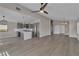 Open-concept living area showcasing a modern kitchen, spacious layout, hardwood floors, and stylish lighting fixtures at 3061 Waterside Cir, Las Vegas, NV 89117