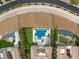 Stunning aerial view of a luxury property featuring a large pool, meticulously manicured landscaping, and multiple lounging areas at 34 Olympia Outlook Dr, Las Vegas, NV 89141