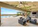 Spacious patio area featuring an outdoor kitchen, fireplace, and infinity pool with mountain views at 34 Olympia Outlook Dr, Las Vegas, NV 89141