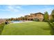 Lush backyard with a pool, outdoor kitchen, and ample lawn space at 34 Olympia Outlook Dr, Las Vegas, NV 89141