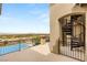 Balcony view showcasing a spiral staircase, wrought iron railing, and panoramic city views beyond the pool at 34 Olympia Outlook Dr, Las Vegas, NV 89141