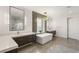 Luxurious bathroom with dual vanities, a freestanding tub, and a glass-enclosed shower, offering a spa-like experience at 34 Olympia Outlook Dr, Las Vegas, NV 89141