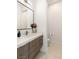 Contemporary bathroom featuring a sleek vanity, modern sink, and stylish mirror with decorative lighting at 34 Olympia Outlook Dr, Las Vegas, NV 89141