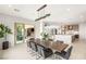 Open dining area flowing into the kitchen and living spaces, featuring a large table for entertaining at 34 Olympia Outlook Dr, Las Vegas, NV 89141