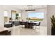 Bright dining room with large windows offering scenic views, complemented by stylish furnishings at 34 Olympia Outlook Dr, Las Vegas, NV 89141