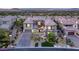 An impressive two-story home with a tile roof, stone accents, manicured landscaping, and a circular driveway at 34 Olympia Outlook Dr, Las Vegas, NV 89141