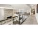 Bright hallway overlooking the living room, showcasing modern railings and an open floor plan with contemporary design at 34 Olympia Outlook Dr, Las Vegas, NV 89141