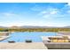 Infinity pool with lounge chairs and fire pit overlooking the valley and city at 34 Olympia Outlook Dr, Las Vegas, NV 89141