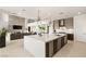 Modern kitchen with a large island and open concept to the living room with fireplace at 34 Olympia Outlook Dr, Las Vegas, NV 89141