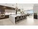 A spacious kitchen featuring modern cabinetry, large island, and adjacent dining area with scenic views at 34 Olympia Outlook Dr, Las Vegas, NV 89141