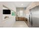 Modern kitchen with stainless steel appliances and neutral backsplash at 34 Olympia Outlook Dr, Las Vegas, NV 89141