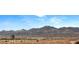 Scenic landscape view showcasing mountains, and a modern building, with residential architecture in the foreground at 34 Olympia Outlook Dr, Las Vegas, NV 89141