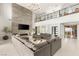 Inviting living room with soaring ceilings, modern fireplace, and access to outdoor patio at 34 Olympia Outlook Dr, Las Vegas, NV 89141