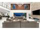 Open living room featuring a fireplace, wood accent wall, and views of the city at 34 Olympia Outlook Dr, Las Vegas, NV 89141