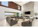 Spacious living room with fireplace, high ceilings, and sliding doors to a patio with city views at 34 Olympia Outlook Dr, Las Vegas, NV 89141