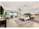 Spacious main bedroom featuring a large bed, balcony access with scenic views, and abundant natural light at 34 Olympia Outlook Dr, Las Vegas, NV 89141