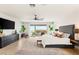 Bright main bedroom with balcony access, showcasing stunning views, a king-size bed, and modern decor at 34 Olympia Outlook Dr, Las Vegas, NV 89141