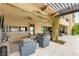 Covered outdoor living space with a wet bar and comfortable seating at 34 Olympia Outlook Dr, Las Vegas, NV 89141