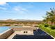 Outdoor seating area with fire pit and pool overlooking city skyline at 34 Olympia Outlook Dr, Las Vegas, NV 89141