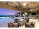 Inviting covered patio with an outdoor kitchen, fireplace, stylish furniture, and views of the pool and city at 34 Olympia Outlook Dr, Las Vegas, NV 89141