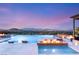 A luxurious pool and spa area with fire features provides a resort-like experience with views of the city skyline at 34 Olympia Outlook Dr, Las Vegas, NV 89141
