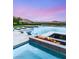 An incredible pool featuring a fire pit and built-in lounge chairs, surrounded by lush greenery and mountain views at 34 Olympia Outlook Dr, Las Vegas, NV 89141