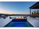 Backyard pool area features a fire pit, outdoor seating, and stunning views of the surrounding landscape at sunset at 34 Olympia Outlook Dr, Las Vegas, NV 89141