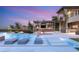 An outdoor oasis features a large pool, built-in lounge chairs, and outdoor kitchen, perfect for entertaining guests at 34 Olympia Outlook Dr, Las Vegas, NV 89141
