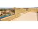 Spacious rooftop deck with wrought iron railing offering views of the neighborhood and nearby swimming pool at 34 Olympia Outlook Dr, Las Vegas, NV 89141