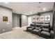 Home theater room features plush seating and sports memorabilia at 34 Olympia Outlook Dr, Las Vegas, NV 89141