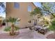 Seating area in backyard with palm trees and a grassy area at 3420 Lockport St, Las Vegas, NV 89129