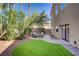 Lush backyard with a desert garden, turf and an outdoor seating area perfect for outdoor activities at 3420 Lockport St, Las Vegas, NV 89129