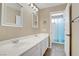 Bathroom showcasing double sinks, white cabinets, and access to a shower-tub combo at 3420 Lockport St, Las Vegas, NV 89129