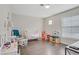 Bright bedroom with dark laminate floors and a view of the front yard through blinds at 3420 Lockport St, Las Vegas, NV 89129