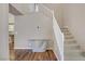 Inviting entryway showcasing wood floors and carpeted stairs with white banisters at 3420 Lockport St, Las Vegas, NV 89129