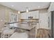 Eat-in kitchen showcasing a stone accent wall, modern white cabinets and a huge island at 3420 Lockport St, Las Vegas, NV 89129